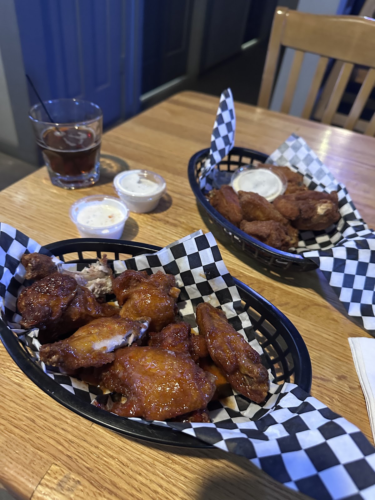 Baskets of saucy chicken wings with ranch